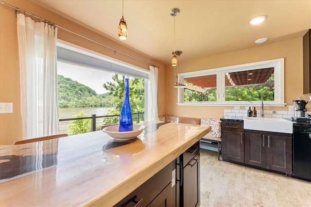 548 Penn St, Verona, PA 15147 - kitchen with light countertops, hanging light fixtures, black dishwasher, and recessed lighting