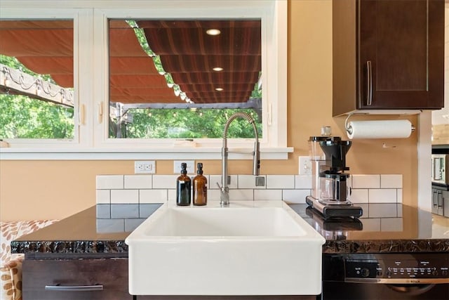 548 Penn St, Verona, PA 15147 - kitchen view of dishwashing machine, dark brown cabinetry, and tasteful backsplash