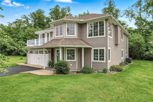 11504 N Shore Dr, Conneaut Lake Cra, PA 16316 - view of front of home with asphalt driveway, a front yard, a balcony, and an attached garage
