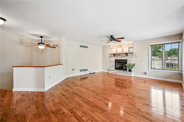 11504 N Shore Dr, Conneaut Lake Cra, PA 16316 - unfurnished living room with a ceiling fan, hardwood / wood-style floors, and a fireplace