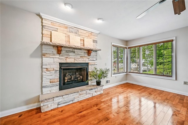 11504 N Shore Dr, Conneaut Lake Cra, PA 16316 - unfurnished living room featuring hardwood / wood-style flooring and a fireplace
