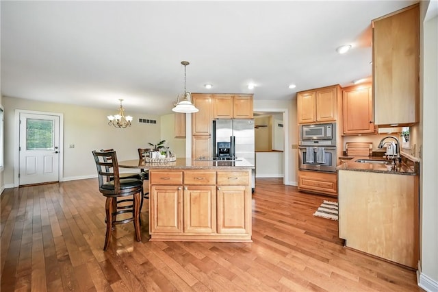 11504 N Shore Dr, Conneaut Lake Cra, PA 16316 - kitchen featuring appliances with stainless steel finishes, light brown cabinetry, light wood-style floors, a center island, and recessed lighting