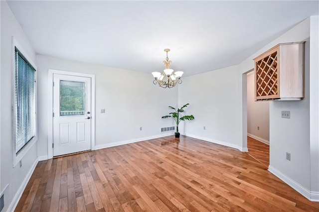 11504 N Shore Dr, Conneaut Lake Cra, PA 16316 - unfurnished dining area with a chandelier and light wood finished floors