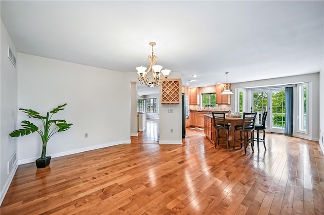 11504 N Shore Dr, Conneaut Lake Cra, PA 16316 - dining space with a chandelier and light wood-type flooring