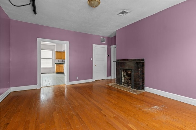 330 Jefferson Ave, City Of Washington, PA 15301 - unfurnished living room with wood-type flooring and a fireplace with flush hearth