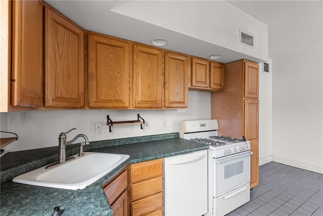 330 Jefferson Ave, City Of Washington, PA 15301 - kitchen featuring white appliances, dark countertops, tile patterned floors, and brown cabinets