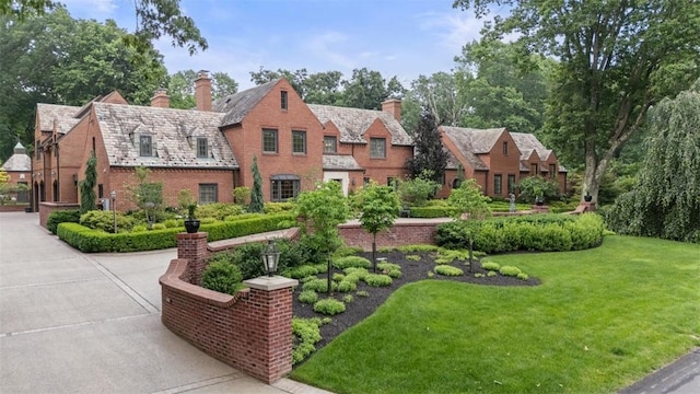 1909 Highgate Rd, Upper St Clair, PA 15241 - view of front of property featuring a high end roof, a chimney, a front yard, and brick siding