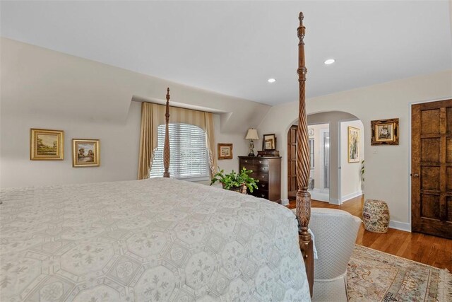 1909 Highgate Rd, Upper St Clair, PA 15241 - bedroom featuring arched walkways, wood finished floors, and recessed lighting