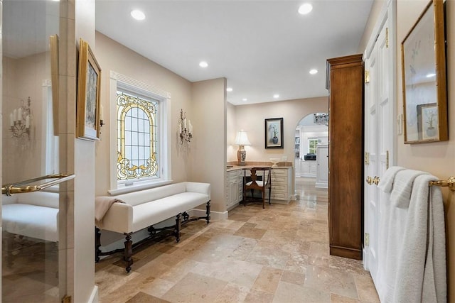 1909 Highgate Rd, Upper St Clair, PA 15241 - hall with arched walkways, healthy amount of natural light, recessed lighting, a desk, and light stone finish flooring