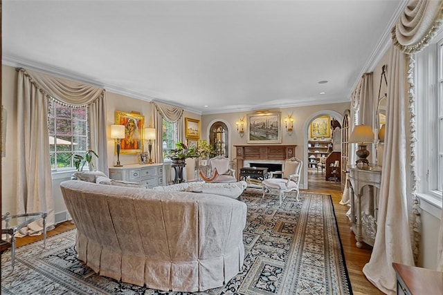 1909 Highgate Rd, Upper St Clair, PA 15241 - living room featuring crown molding, wood finished floors, arched walkways, and a fireplace
