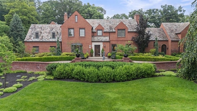 1909 Highgate Rd, Upper St Clair, PA 15241 - tudor-style house with a high end roof, a chimney, and a front yard