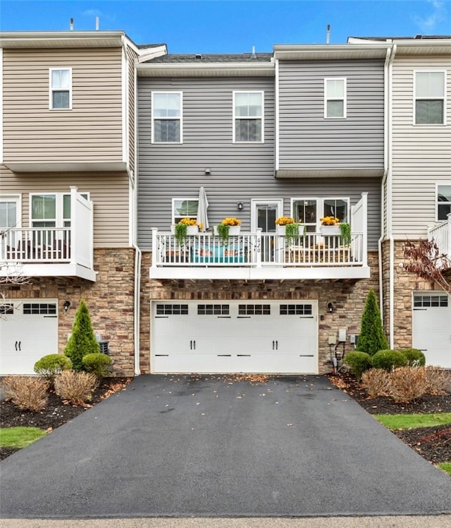 620 Amarth Ln, Cranberry Twp, PA 16066 - rear view of property with stone siding, driveway, and an attached garage