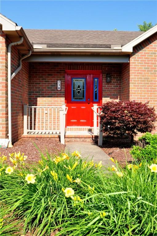 23 Naples Dr, North Union Twp, PA 15401 - doorway to property featuring brick siding and a shingled roof