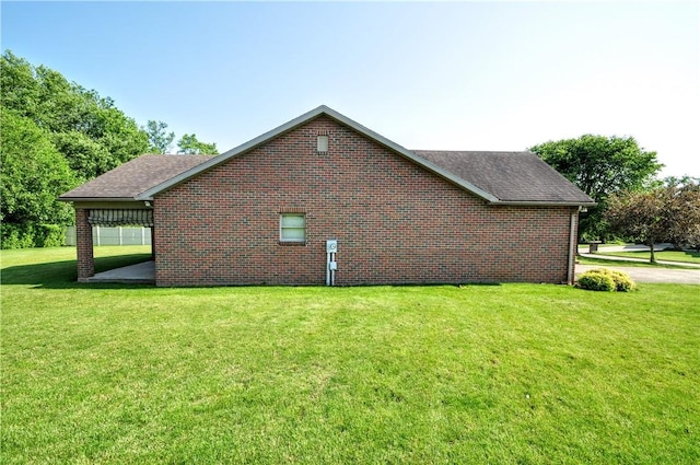 23 Naples Dr, North Union Twp, PA 15401 - view of side of home featuring brick siding, a lawn, and a shingled roof