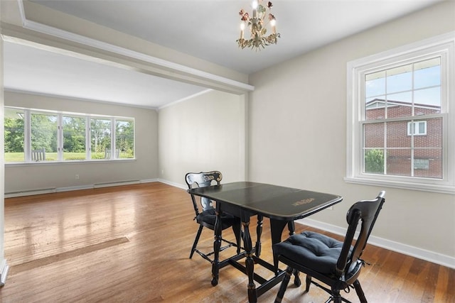 95 Karen Dr, Buffalo Twp Wsh, PA 15301 - dining space featuring wood finished floors, a chandelier, a baseboard heating unit, and crown molding