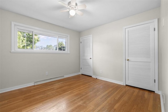 95 Karen Dr, Buffalo Twp Wsh, PA 15301 - unfurnished bedroom with a baseboard heating unit, light wood-style flooring, two closets, and a ceiling fan