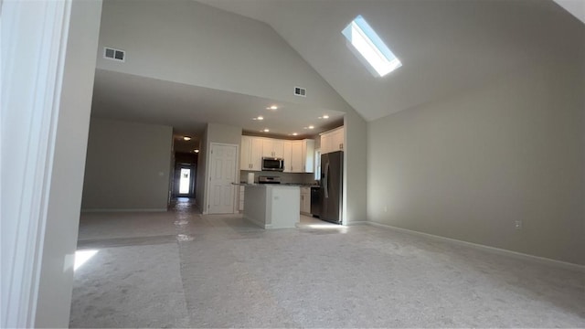 150 Shady River Blvd Unit 56A, Economy, PA 15005 - unfurnished living room featuring high vaulted ceiling, a skylight, light colored carpet, and recessed lighting