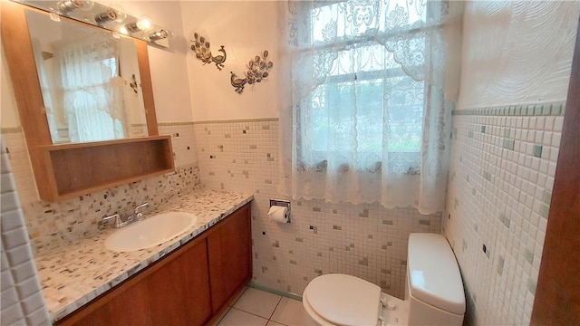14099 Lincoln Way N, Huntingdon, PA 15642 - bathroom with tile walls, tile patterned floors, vanity, and a wainscoted wall
