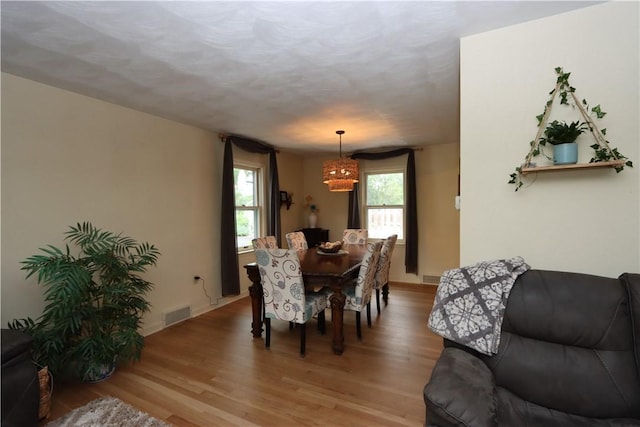 3244 37th St, Chippewa Twp, PA 15010 - dining area with light wood-style flooring and a chandelier