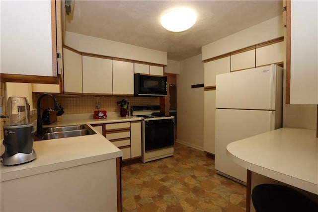 3244 37th St, Chippewa Twp, PA 15010 - kitchen featuring stove, freestanding refrigerator, black microwave, light countertops, and backsplash