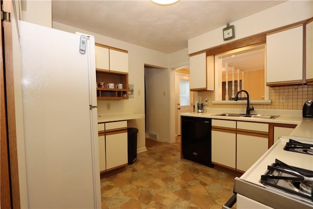 3244 37th St, Chippewa Twp, PA 15010 - kitchen with freestanding refrigerator, black dishwasher, tasteful backsplash, light countertops, and white cabinetry