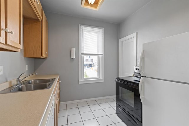 150 Frank St, Whitaker, PA 15120 - kitchen with freestanding refrigerator, electric range, light countertops, light tile patterned floors, and brown cabinetry