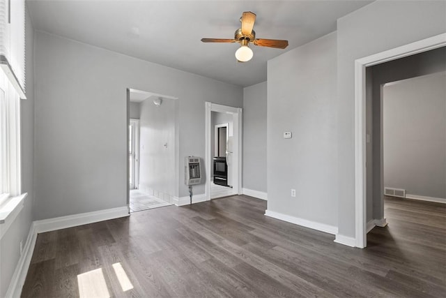 150 Frank St, Whitaker, PA 15120 - unfurnished bedroom featuring heating unit, dark wood-style floors, and ceiling fan