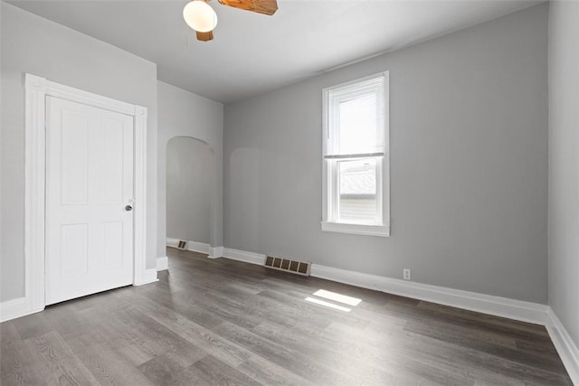 150 Frank St, Whitaker, PA 15120 - unfurnished bedroom with wood finished floors, ceiling fan, and arched walkways
