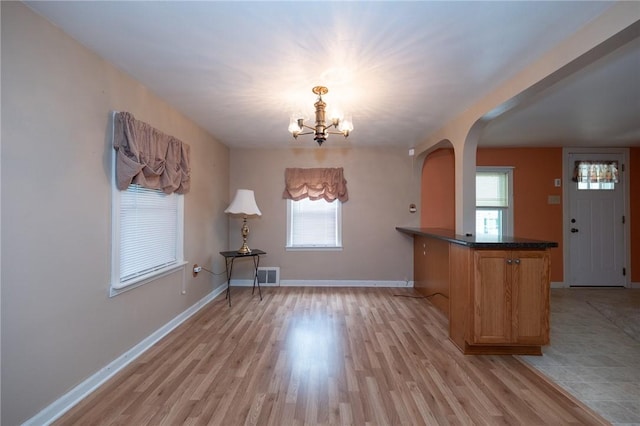 1539 Dime Rd, Parks Twp, PA 15690 - unfurnished dining area with arched walkways, a chandelier, and light wood-style floors