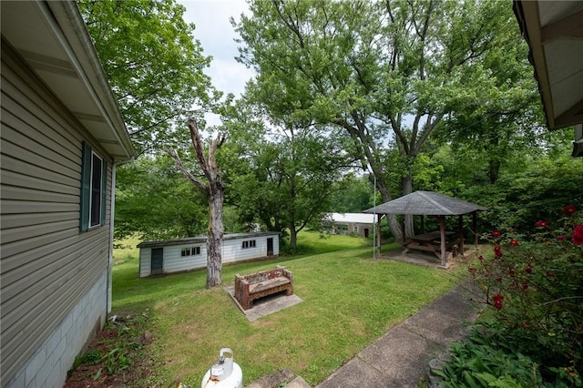 1539 Dime Rd, Parks Twp, PA 15690 - view of green lawn with an outbuilding, view of wooded area, a gazebo, and a fire pit