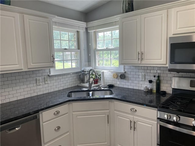 10240 Roseway Blvd, North Huntingdon, PA 15642 - kitchen featuring stainless steel appliances, white cabinetry, backsplash, and dark stone counters