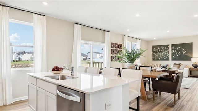 346 Leslie Farms Dr, Connoquenessing Boro, PA 16033 - kitchen with dishwasher, a kitchen island with sink, open floor plan, light wood-type flooring, and white cabinetry
