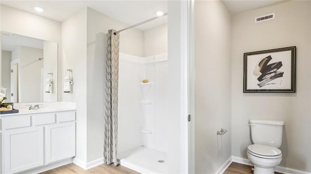 346 Leslie Farms Dr, Connoquenessing Boro, PA 16033 - bathroom featuring vanity, curtained shower, and wood finished floors