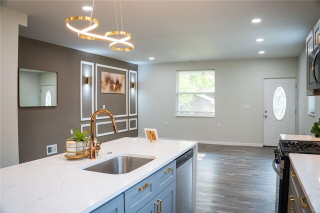 428 Donna, Garfield, PA 15224 - kitchen featuring appliances with stainless steel finishes, hanging light fixtures, dark wood-style floors, recessed lighting, and light stone counters