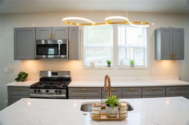 428 Donna, Garfield, PA 15224 - kitchen featuring appliances with stainless steel finishes, gray cabinets, plenty of natural light, and light stone counters