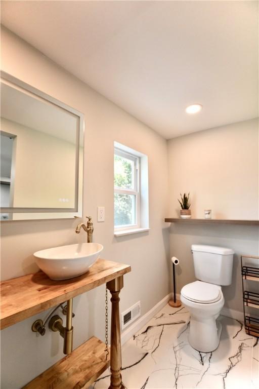 428 Donna, Garfield, PA 15224 - bathroom featuring marble look tile flooring and recessed lighting