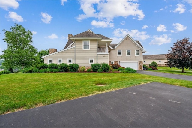 1041 Ashfield Way, Salem Twp Wml, PA 15601 - view of front facade featuring a chimney, a garage, driveway, and a front lawn