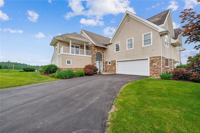 1041 Ashfield Way, Salem Twp Wml, PA 15601 - view of front facade with stone siding, driveway, an attached garage, and a front lawn
