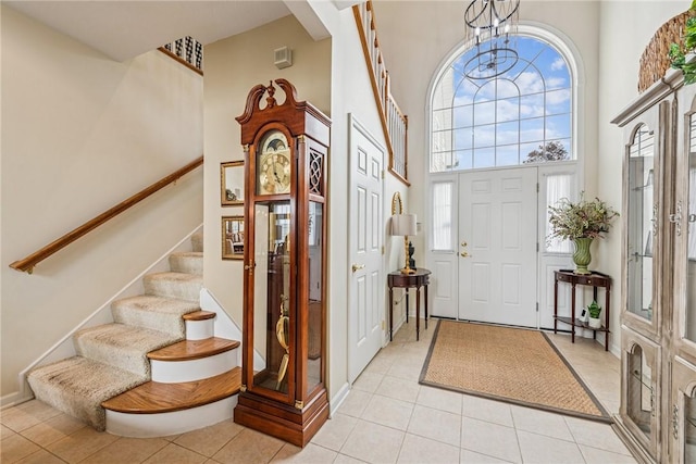 1041 Ashfield Way, Salem Twp Wml, PA 15601 - entrance foyer with a towering ceiling, stairway, a chandelier, and light tile patterned flooring