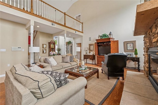 1041 Ashfield Way, Salem Twp Wml, PA 15601 - living area featuring a towering ceiling, a fireplace, and wood finished floors