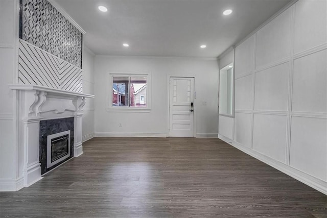 322 S Broadway St, Scottdale, PA 15683 - unfurnished living room with a high end fireplace, dark wood-type flooring, recessed lighting, and a decorative wall
