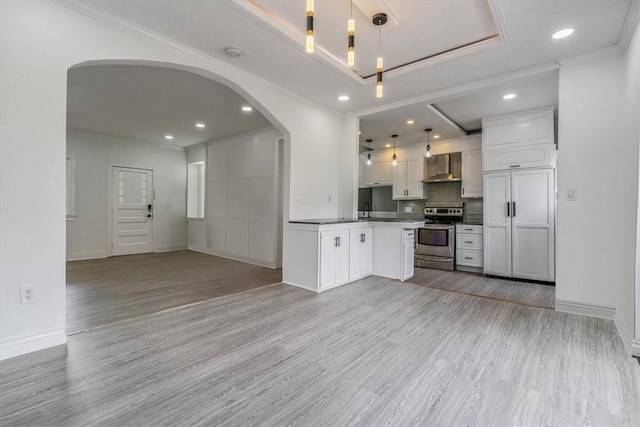 322 S Broadway St, Scottdale, PA 15683 - kitchen with electric range, wall chimney exhaust hood, open floor plan, arched walkways, and recessed lighting
