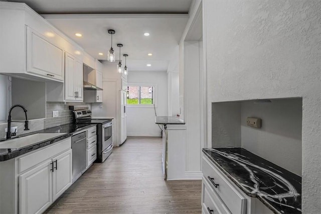 322 S Broadway St, Scottdale, PA 15683 - kitchen with appliances with stainless steel finishes, wood finished floors, recessed lighting, white cabinets, and backsplash