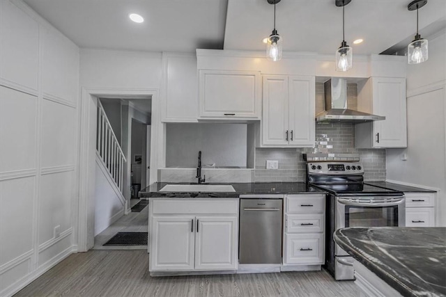 322 S Broadway St, Scottdale, PA 15683 - kitchen featuring appliances with stainless steel finishes, wall chimney exhaust hood, white cabinetry, light wood-style floors, and recessed lighting