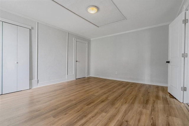 322 S Broadway St, Scottdale, PA 15683 - unfurnished bedroom featuring light wood-type flooring, crown molding, and a closet