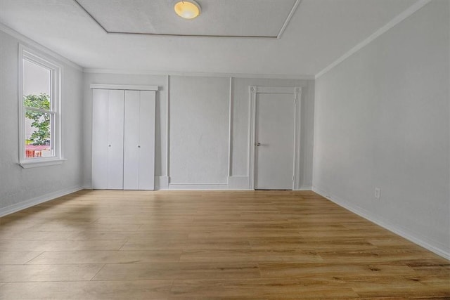 322 S Broadway St, Scottdale, PA 15683 - unfurnished bedroom with light wood-style floors, ornamental molding, and a closet