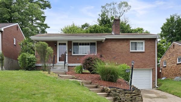 1657 Pembroke Dr, Pittsburgh, PA 15243 - view of front of home featuring a garage, driveway, brick siding, a chimney, and a front lawn