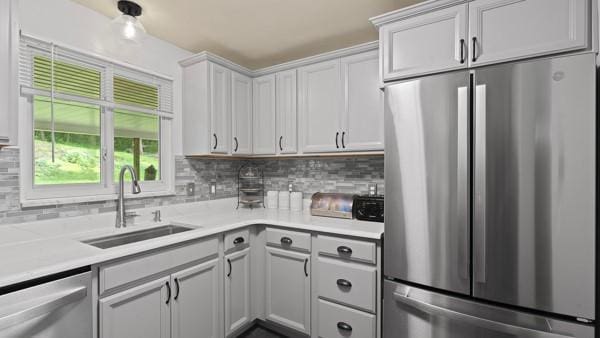 1657 Pembroke Dr, Pittsburgh, PA 15243 - kitchen featuring stainless steel appliances, light countertops, backsplash, and white cabinets