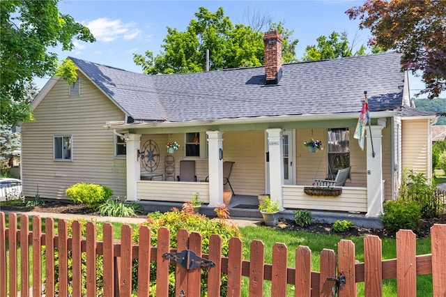 12091/2 Vance Ave, Coraopolis, PA 15108 - bungalow-style house with a porch, a fenced front yard, a chimney, and a shingled roof