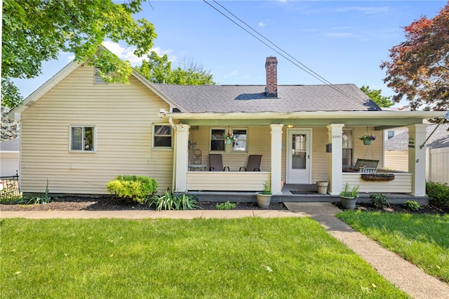 12091/2 Vance Ave, Coraopolis, PA 15108 - bungalow with a porch, a front lawn, a chimney, and a shingled roof